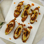 Crostini met witte bonenspread, artisjok en Italiaanse crispy chili oil